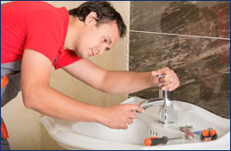 Plumber is repairing a faucet